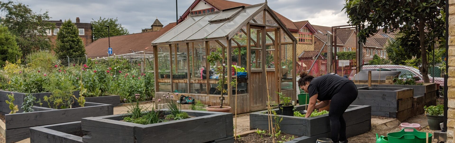 community garden with green house in center